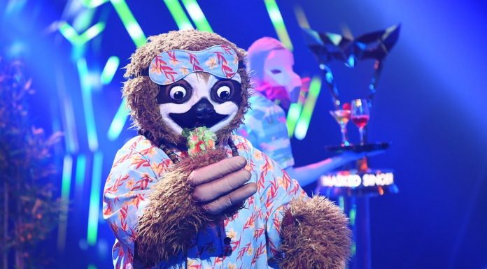 The sloth sings and dances to the "The Masked Singer" trophy